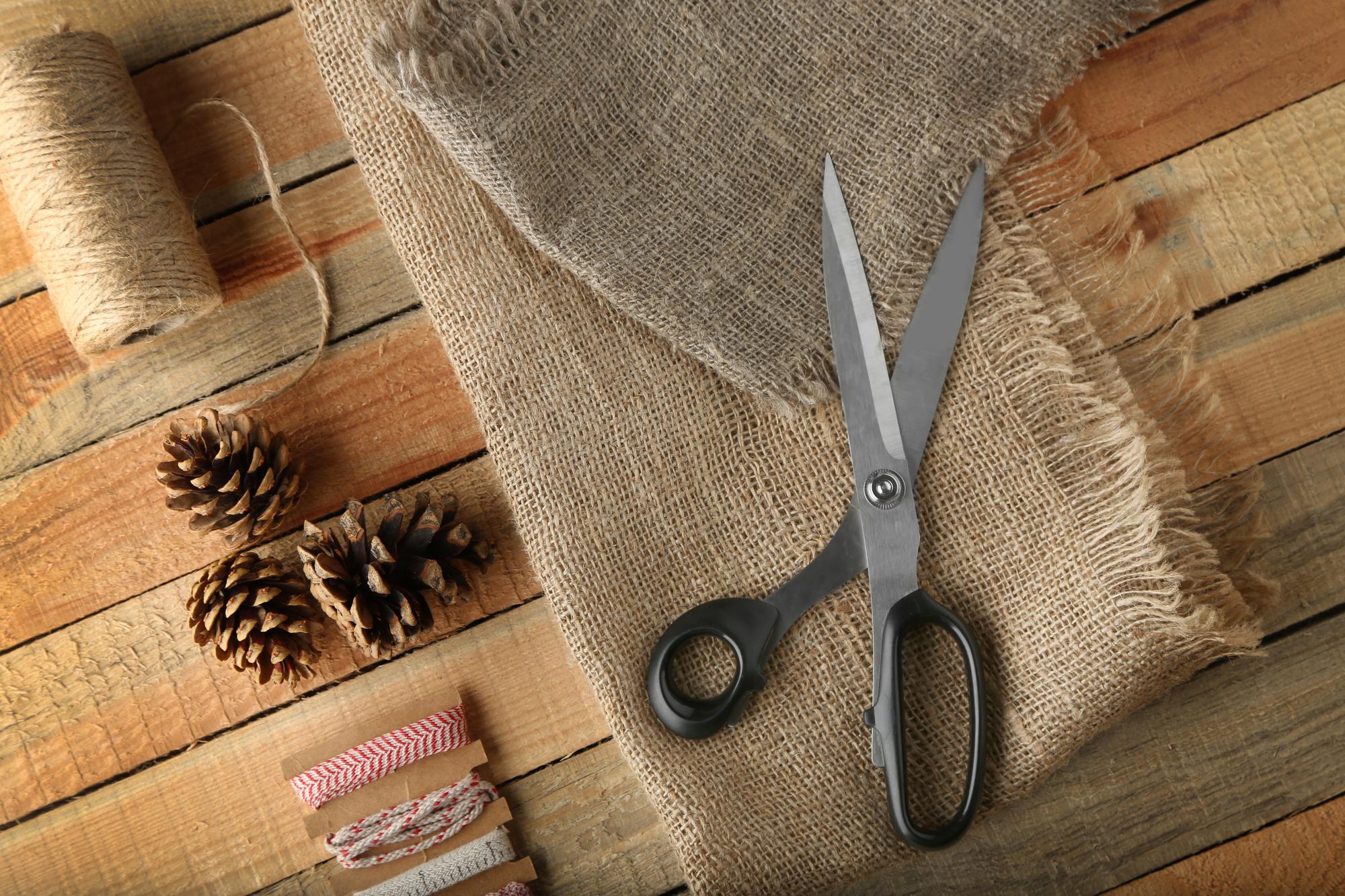 Selection of threads and scissors on linen